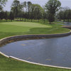 A green view with water on the right at  Laguna Oaks Golf Course